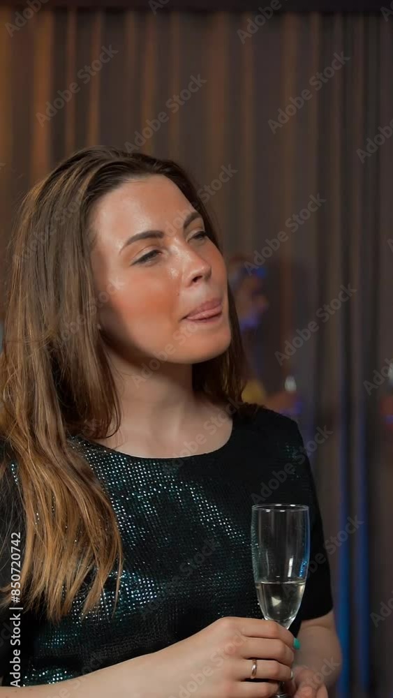 Two sexy attractive handsome young ladies gossiping with clinking glasses of sparkled wine. They happy of conversation at the party. 4k UHD. Vertical shot. Two sexy attractive handsome young ladies gossiping with clinking glasses of sparkled wine. They happy of conversation at the party. 4k UHD. Vertical shot.