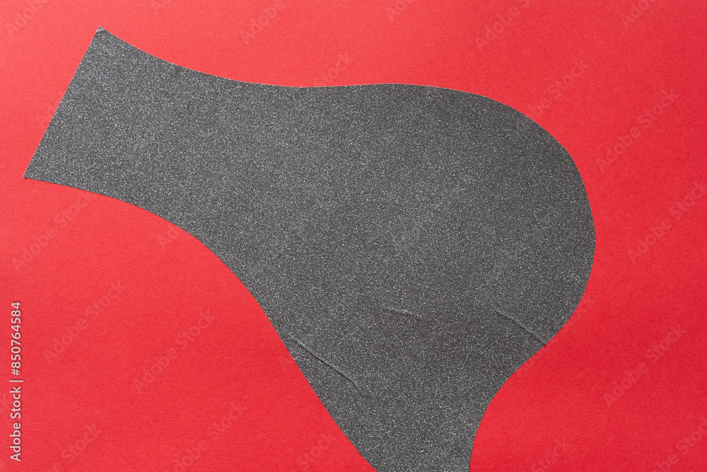 abstract cut vinyl shape (gray glitter) on red paper abstract cut vinyl shape (gray glitter) on red paper