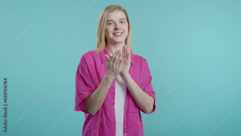 Smiling young woman claps hands, congratulating. Support, cheering, gratitude Smiling young woman claps hands, congratulating. Support, cheering, gratitude