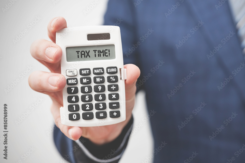 Businessman holding calculator. Tax concept Businessman holding calculator. Tax concept