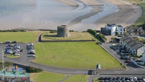 Medieval Tower Overlooking Serene Sea and Beach: Aerial Drone Footage