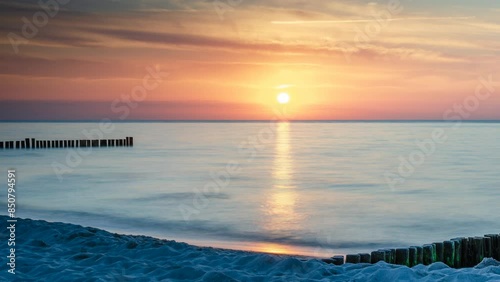 Time lapse. Beautiful sunset at the beach of Kuehlungsborn, a Seebad (seaside resort) town in the Rostock district, in Mecklenburg-Vorpommern, Germany photo