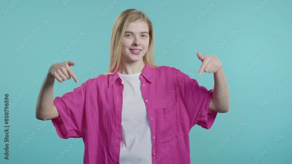 Blogger cheerful woman pointing to advertising area. Blue studio.Click subscribe Blogger cheerful woman pointing to advertising area. Blue studio.Click subscribe