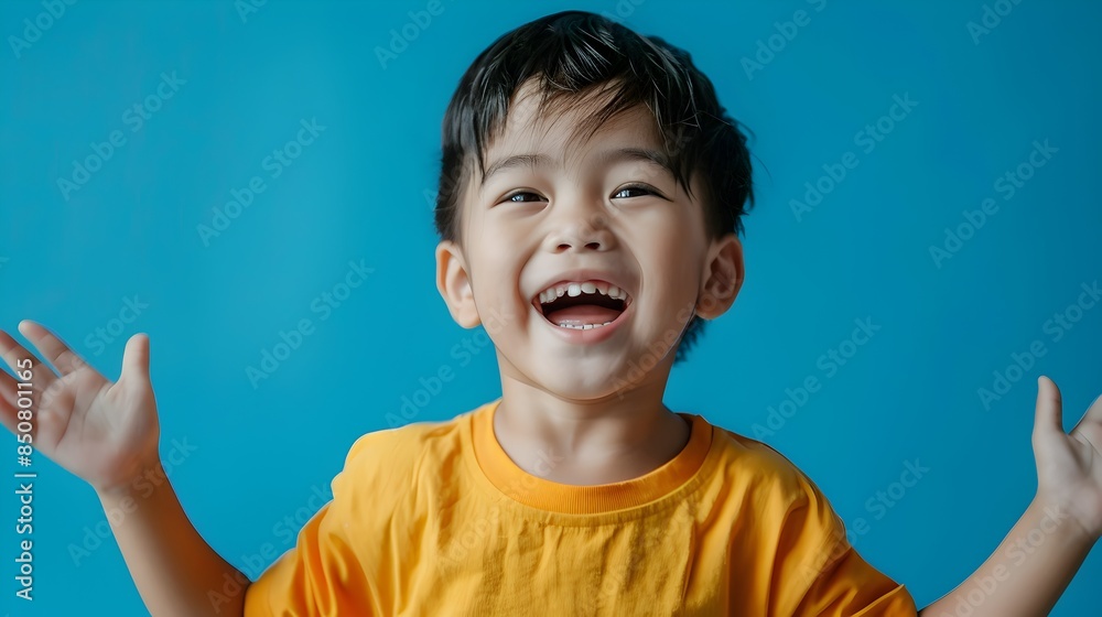 Carefree Asian Boy Laughing with Joy and Happiness in Studio Carefree Asian Boy Laughing with Joy and Happiness in Studio