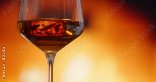 Close up of glass of wine with fire pit in the background