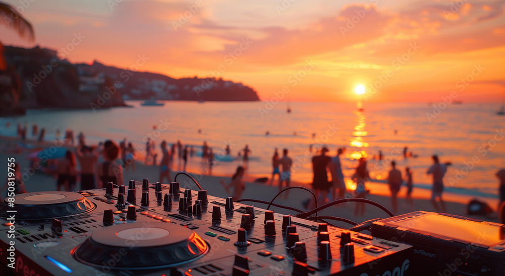 Obraz premium A close-up shot of hands on turntables, with people dancing in soft focus behind at sunset during an outdoor party. A photo of DJ equipment on the beach with a sunset and crowd in the background. 