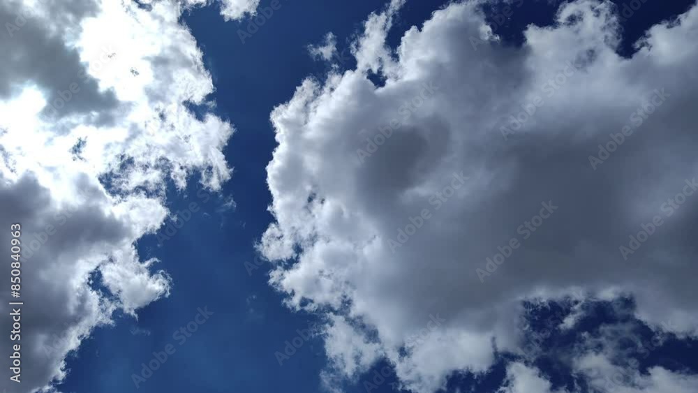 Sky is divided into three by large illuminated clouds