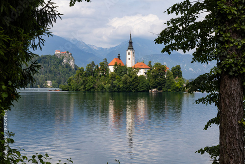 Panoramic view from Lake Bled, beauty heritage in Slovenia. Island with church and castle in the background create a dream setting. View from Ojstrica and Mala Osojnica with the heart-shaped bench. photo