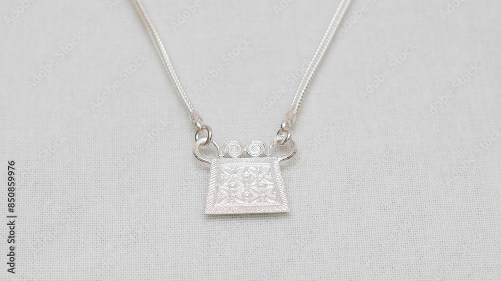Handmade Hmong or Miao silver jewelry display on white background Handmade Hmong or Miao silver jewelry display on white background