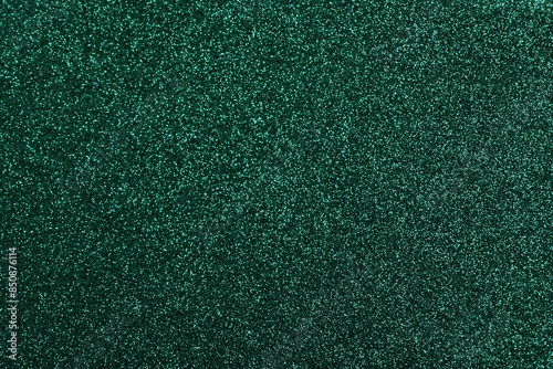 Shiny dark green glitter as background, closeup photo