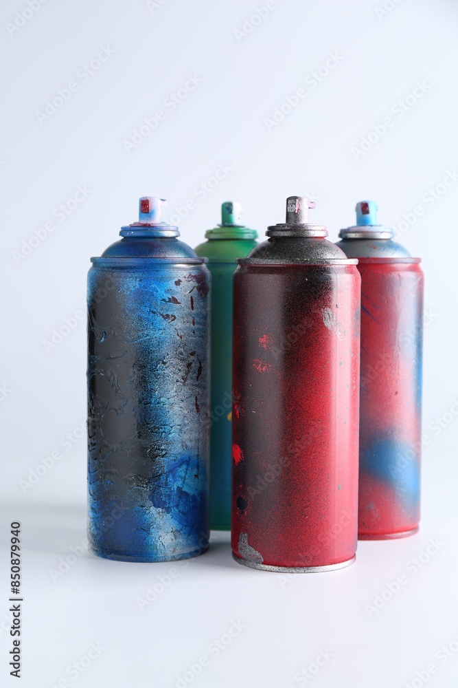 Many spray paint cans on white background Many spray paint cans on white background