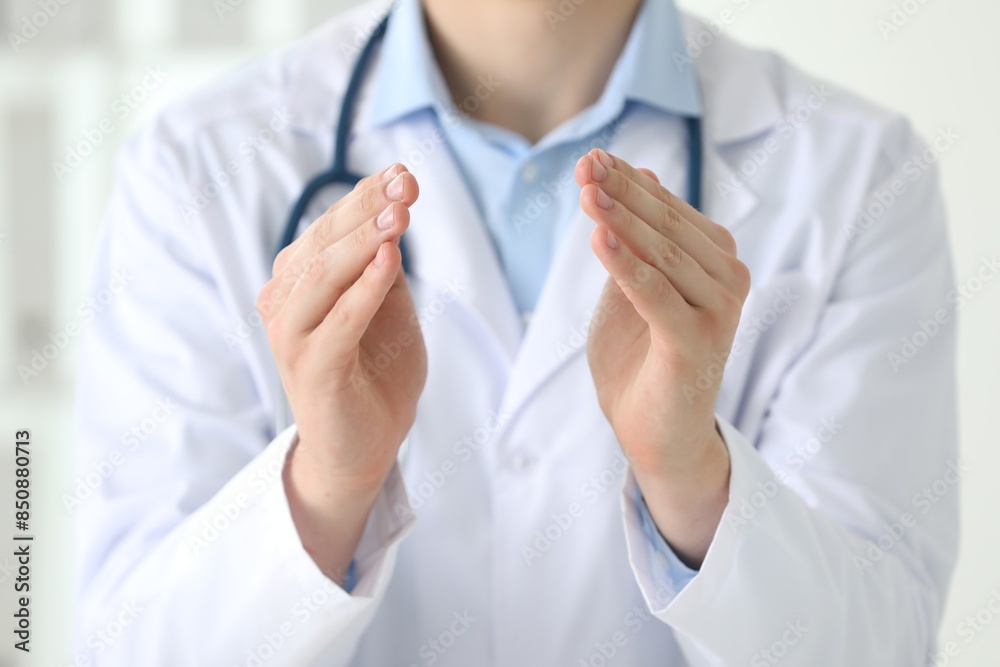 Doctor holding something in clinic, closeup view