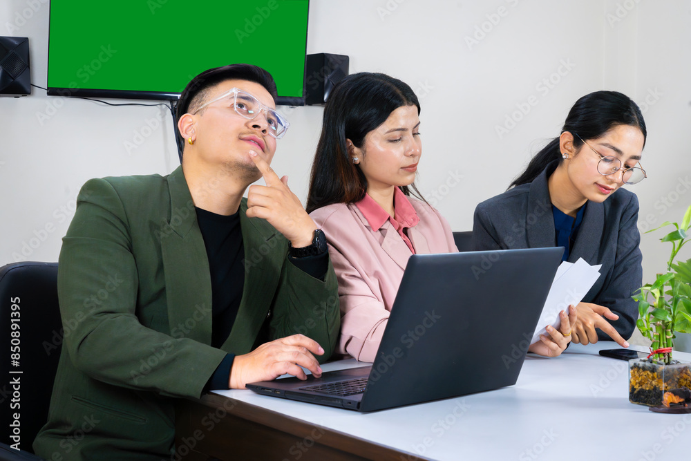 an office team of business man and woman in front of a green screen in a meeting table discussing an office team of business man and woman in front of a green screen in a meeting table discussing