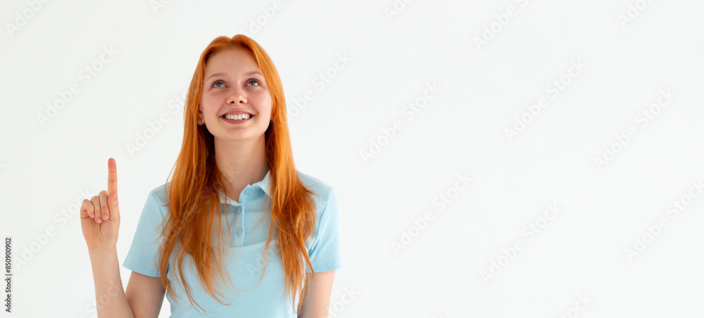 Smiling woman pointing finger up over white background Smiling woman pointing finger up over white background