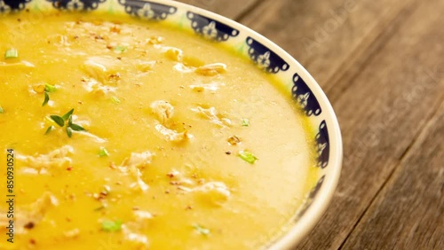 Manioc shredded chicken soup with fresh herbs and pepper photo