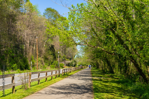 Background of greenery path. Roswell Riverwalk Boardwalk is a 7-mile off-road path that runs along the Chattahoochee River in Roswell, Georgia, Fulton County. A beautiful walking path along the river