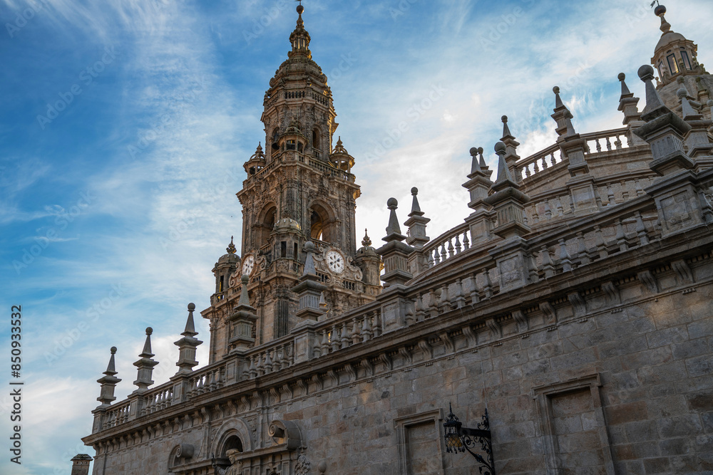 Baroque facade of a historical building with ornate sculptures and emblem, set against a blue sky with wispy clouds, possibly in Europe during spring. Baroque facade of a historical building with ornate sculptures and emblem, set against a blue sky with wispy clouds, possibly in Europe during spring.