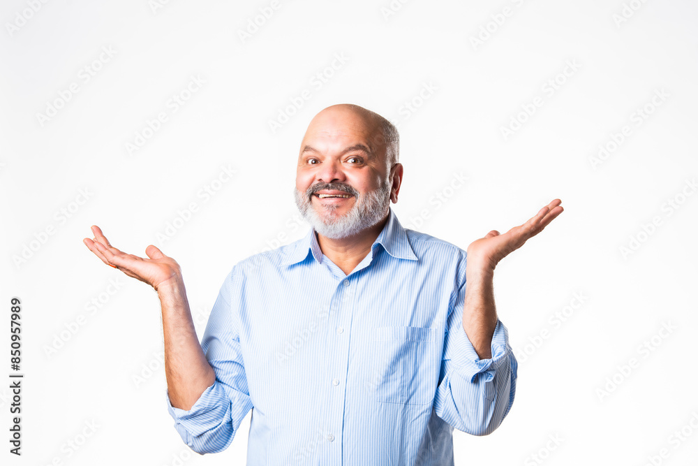Cheerful Indian asian senior retired old man pointing finger at blank, showing something Cheerful Indian asian senior retired old man pointing finger at blank, showing something