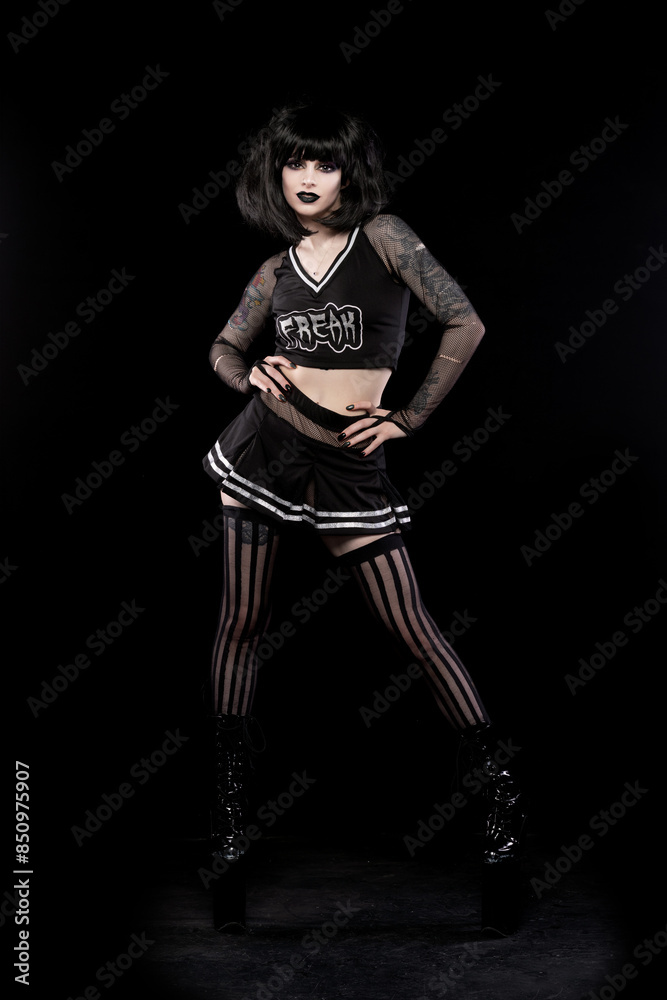 Beautiful goth punk model in studio on black background Beautiful goth punk model in studio on black background