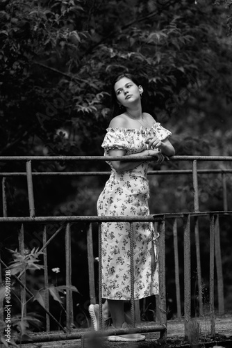 Portrait of a young beautiful dark-haired girl. Black and white photo.