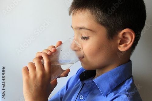 child drinks clean water from a glass