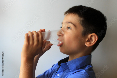 boy drinks clean water from a glass