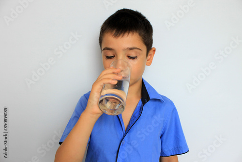 boy drinks water from a glass