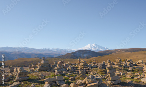 Obraz na płótnie Mountain Elbrus. Autumn Elbrus. Autumn in the Caucasus mountains. Gilli-Suu district. Landscape of snow-capped mountains through stone pyramids. Snowy peaks. Panorama of Elbrus. w salonie