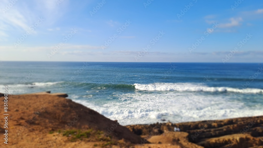 Powerful ocean waves crashing on the shore on a sunny day Powerful ocean waves crashing on the shore on a sunny day