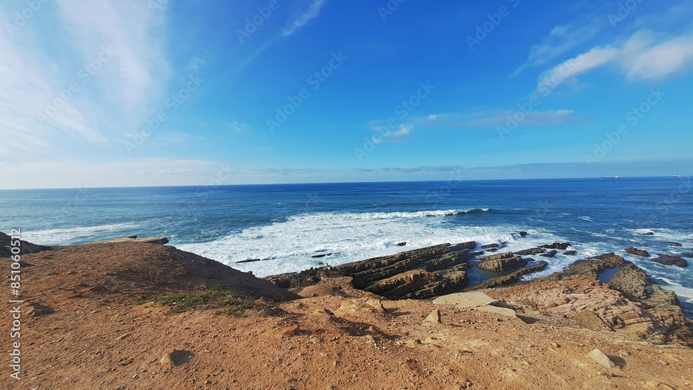 Rocky coastline meeting the ocean on a sunny day Rocky coastline meeting the ocean on a sunny day