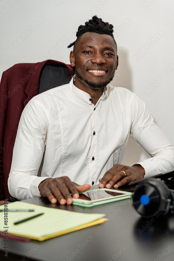 Smiling young businessman working at desk in office Smiling young businessman working at desk in office