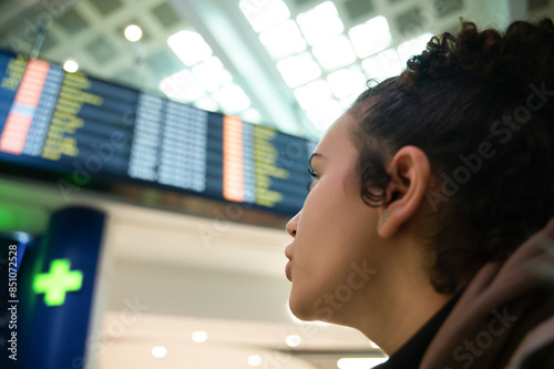 Woman checking flight information at airport