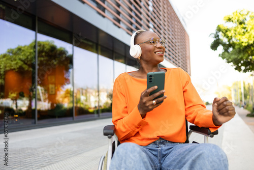 Black woman in wheelchair enjoying music outdoors