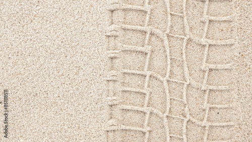 Detailed View of a Tire Track Left on a Sandy Beach Shoreline, Nature Transportation Adventure Scene photo