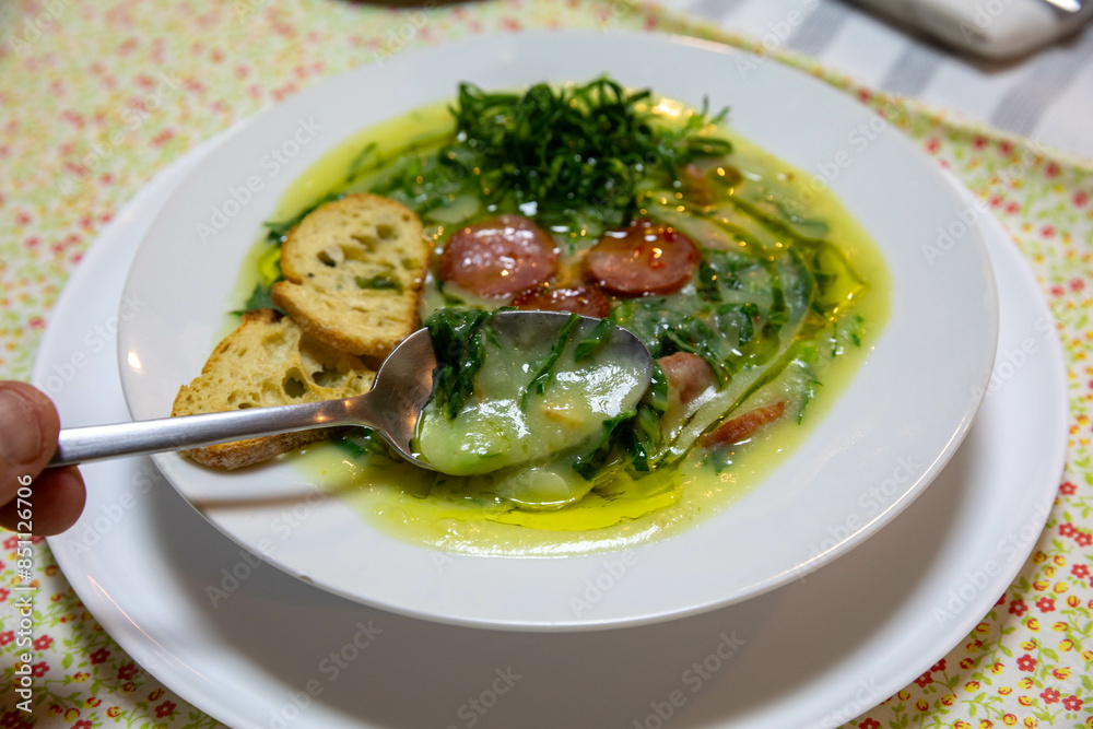 Traditional Portuguese green broth with potatoes, cabbage and chorizo sausage Traditional Portuguese green broth with potatoes, cabbage and chorizo sausage