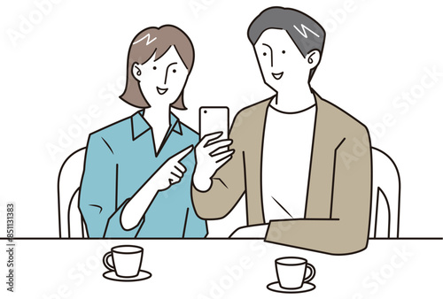 スマホを見ながら会話する若い男女
