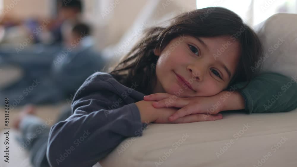 A boy with long dark hair and a gentle smile gazes at the camera in the warm, cozy light of his home, creating a tranquil scene. A boy with long dark hair and a gentle smile gazes at the camera in the warm, cozy light of his home, creating a tranquil scene.