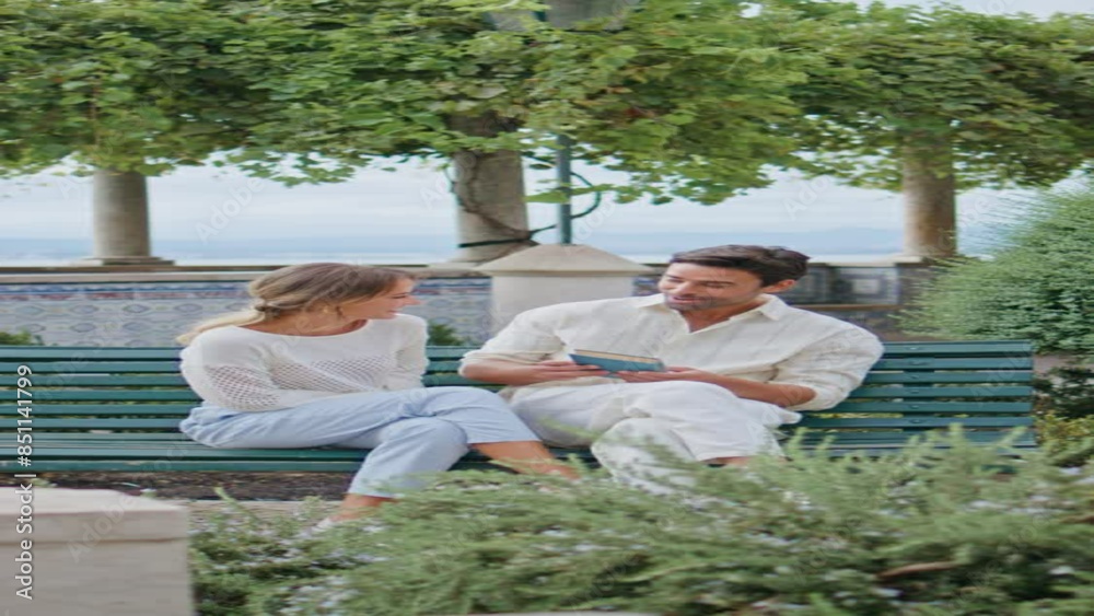 Cheerful couple sitting bench laughing park vertically. Lovely pair kissing date Cheerful couple sitting bench laughing park vertically. Lovely pair kissing date