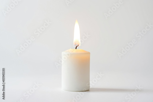 Single Burning Candle on a White Background