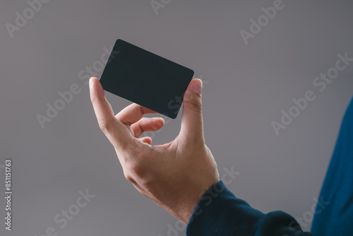 businessman is using a empty credit card  for financial transactions. Online banking purchase product on internet in home office or online shopping. Convenience in the world of technology.