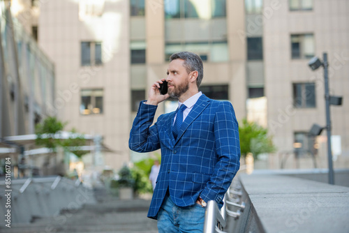 Businessman talking on phone. Businessman in front office. Social network. Hispanic business man with phone office building. Businessman using smartphone. Man phone conversation in city. Mobile phone © be free