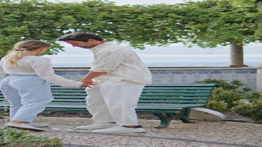 Tender lovers walking park holding hands back view vertically. Couple strolling