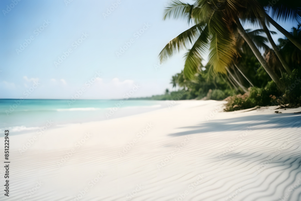 Obraz premium Close-up of soft sand on a tropical beach on a sunny day, with a blurry sea and coconut palm in the background. This idyllic scene captures the essence of a perfect holiday destination.