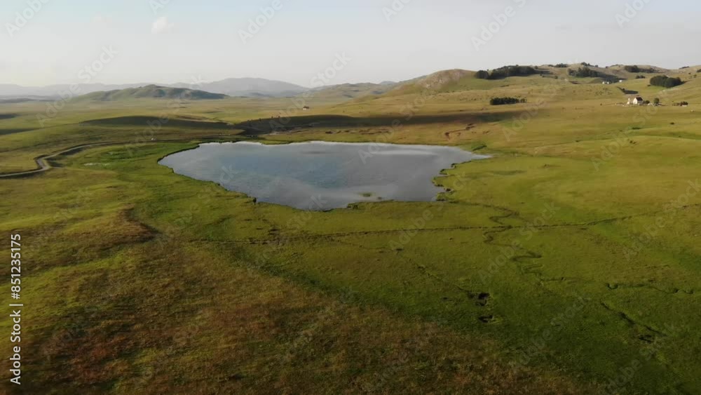 Blue Enemy Lake on a green meadow in a mountain valley. Durmitor, Montenegro Blue Enemy Lake on a green meadow in a mountain valley. Durmitor, Montenegro