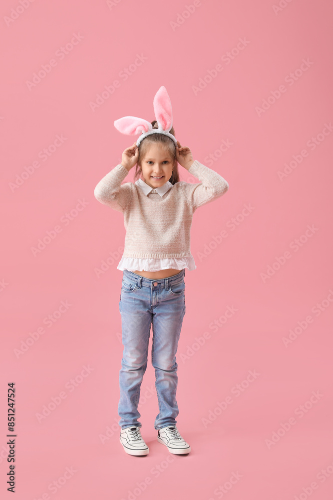 Cute little girl in bunny ears on pink background Cute little girl in bunny ears on pink background