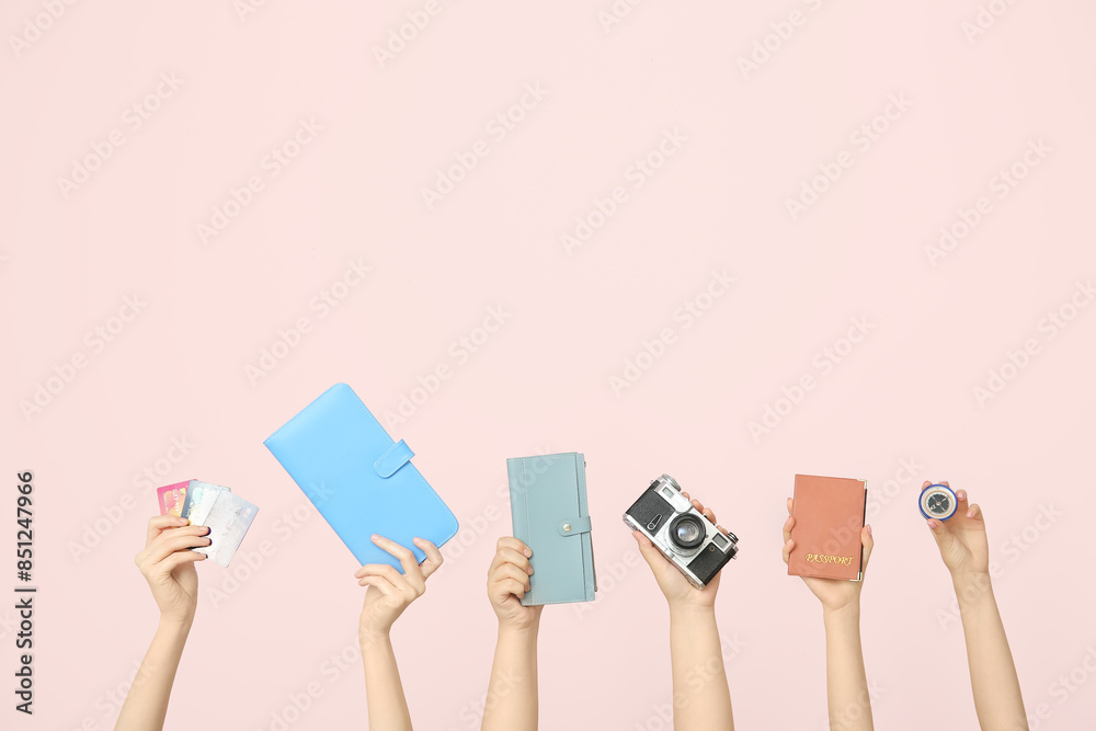 Female hands with credit cards, wallets, photo camera, passport and compass on beige background. Travel concept Female hands with credit cards, wallets, photo camera, passport and compass on beige background. Travel concept