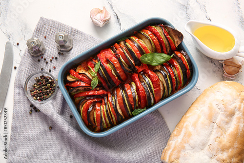 Baking dish of tasty Ratatouille on white marble background