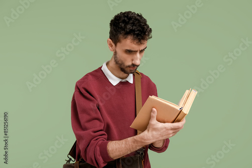 Male student with book on g...