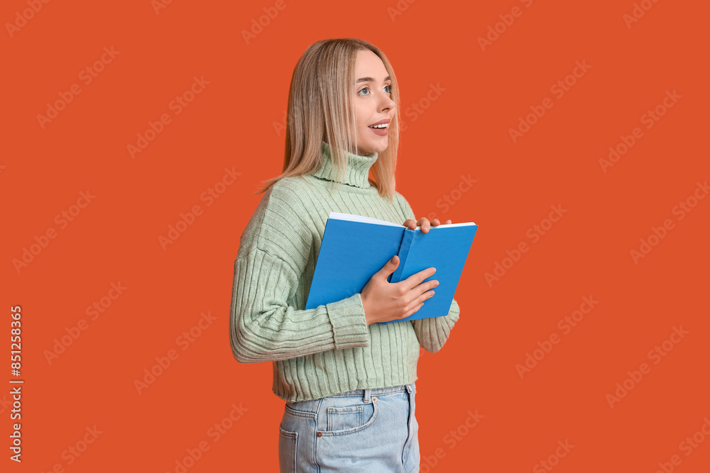 Beautiful young happy woman with book on red background Beautiful young happy woman with book on red background