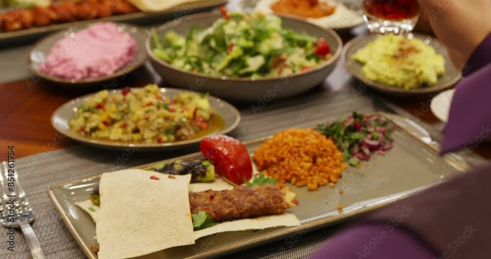 People sit at a table in a restaurant and eat People sit at a table in a restaurant and eat
